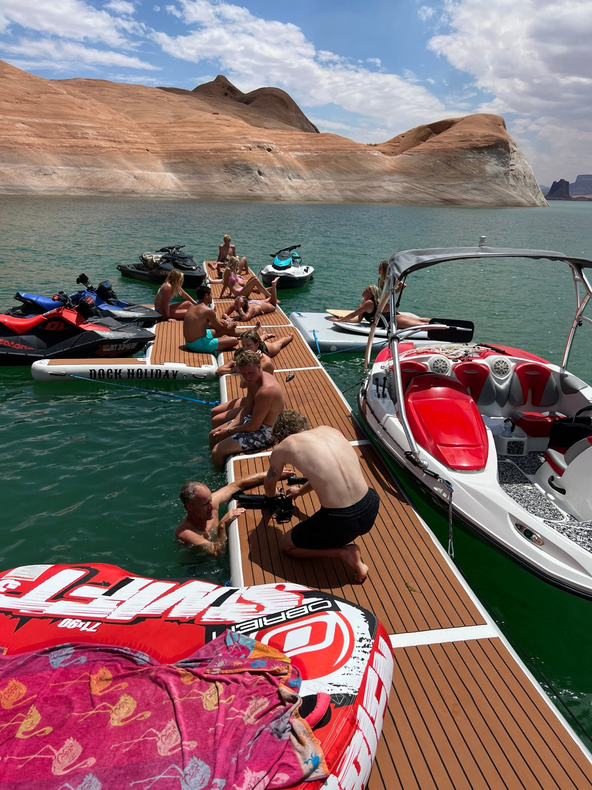 Friends relaxing on a Dock Holiday inflatable platform